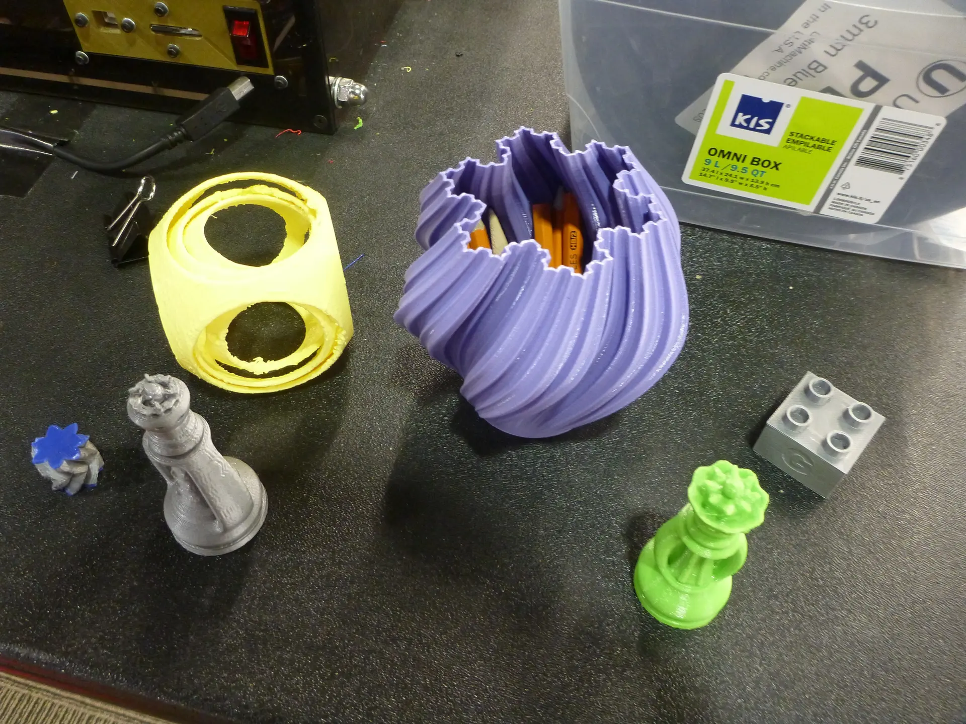 A collection of colourful 3D-printed objects on a desk